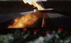 Un bărbat își face un grătar la flacăra eternă de monumentul soldaților căzuți în Al Doilea Război Mondial